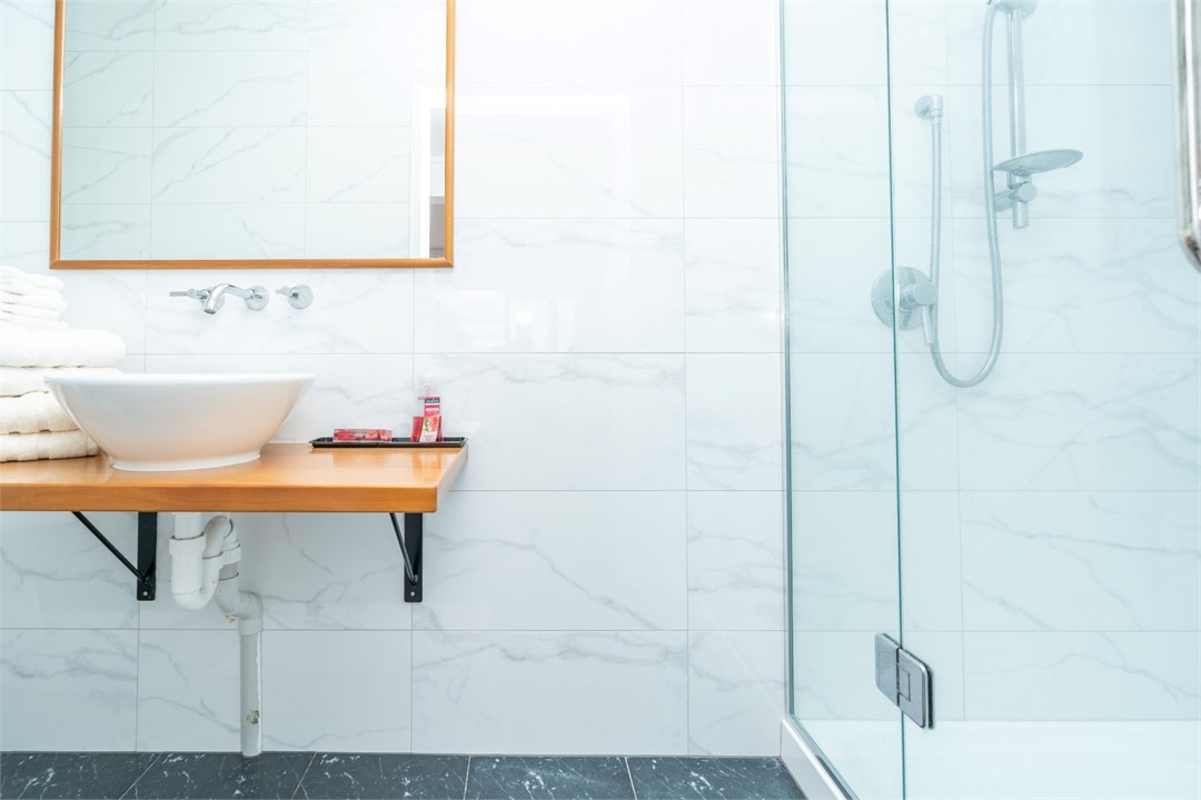 Bathroom has shower and a toilet