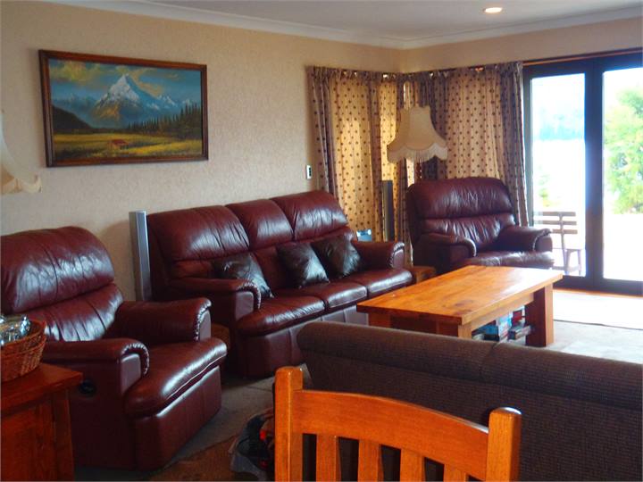 Lounge has a woodburner & heat pump. Views Lake Ha