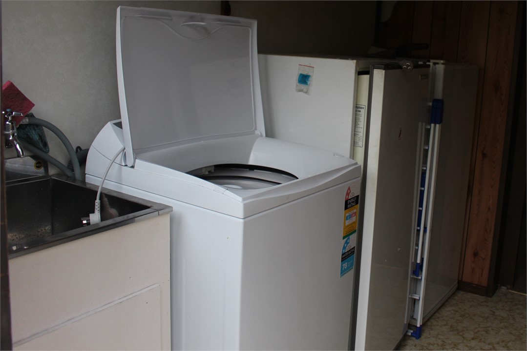 Laundry with 2nd fridge, freezer, dryer in garage
