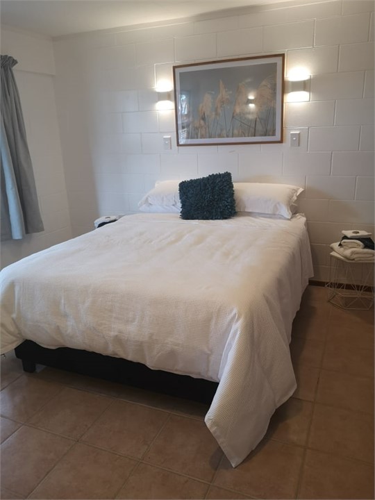 queen size bed in spacious bedroom