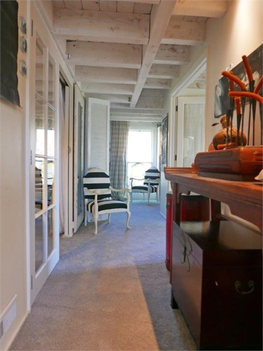 The hallway on the first level leads to all 3 bedr