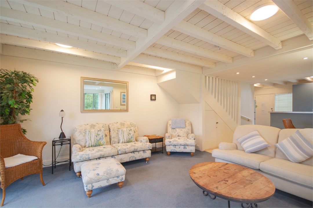 Living room has a TV and seating areas