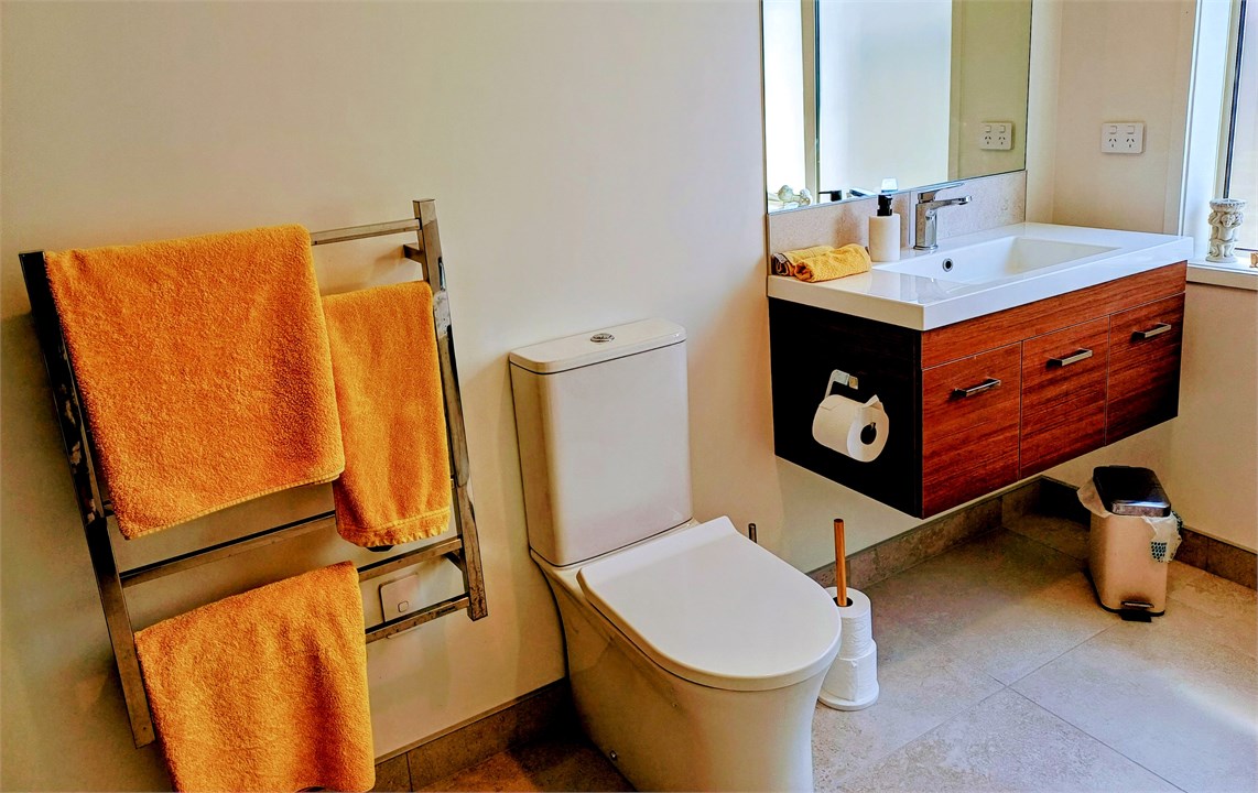 Bright modern bathroom including toilet, shower an