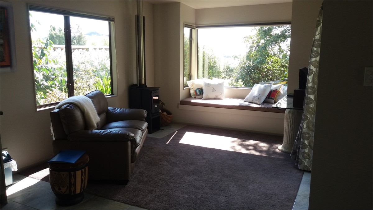 Livingroom with window seat and woodburner