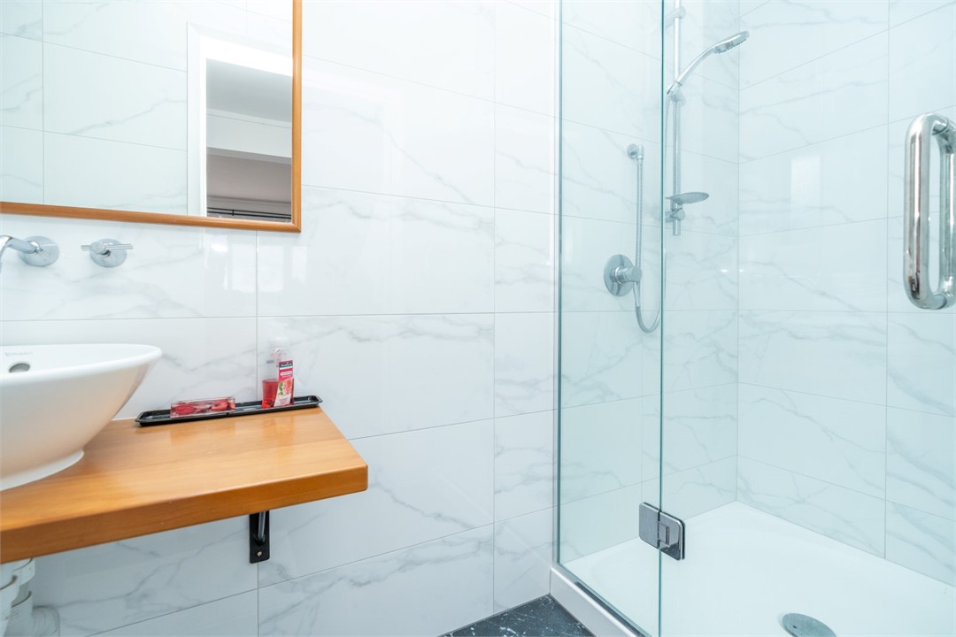 Bathroom has shower and a toilet