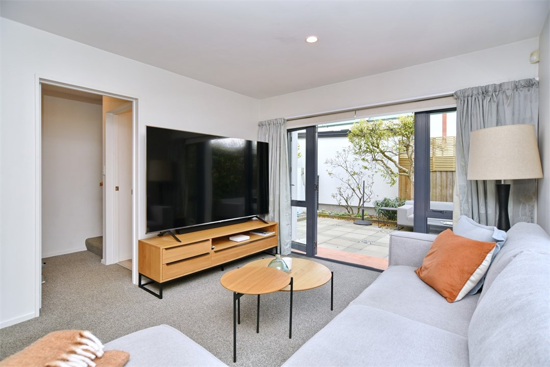 Living room has a TV and seating areas