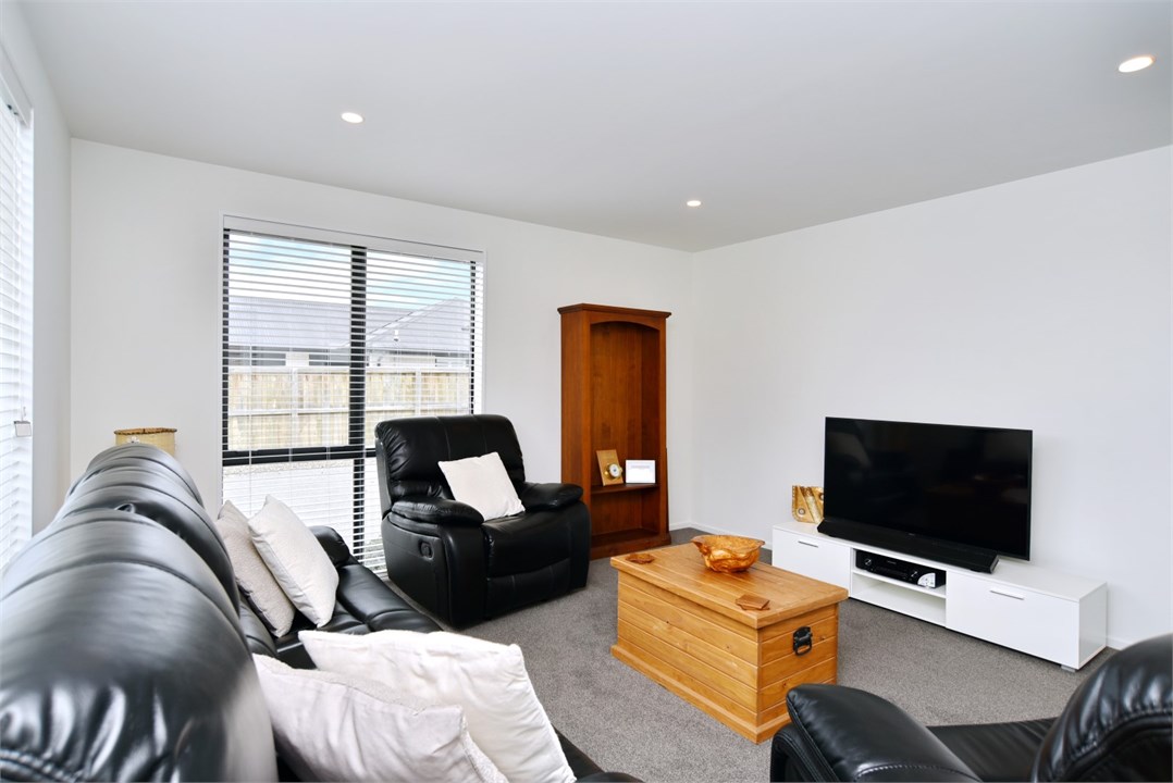 Living room has a TV and seating areas