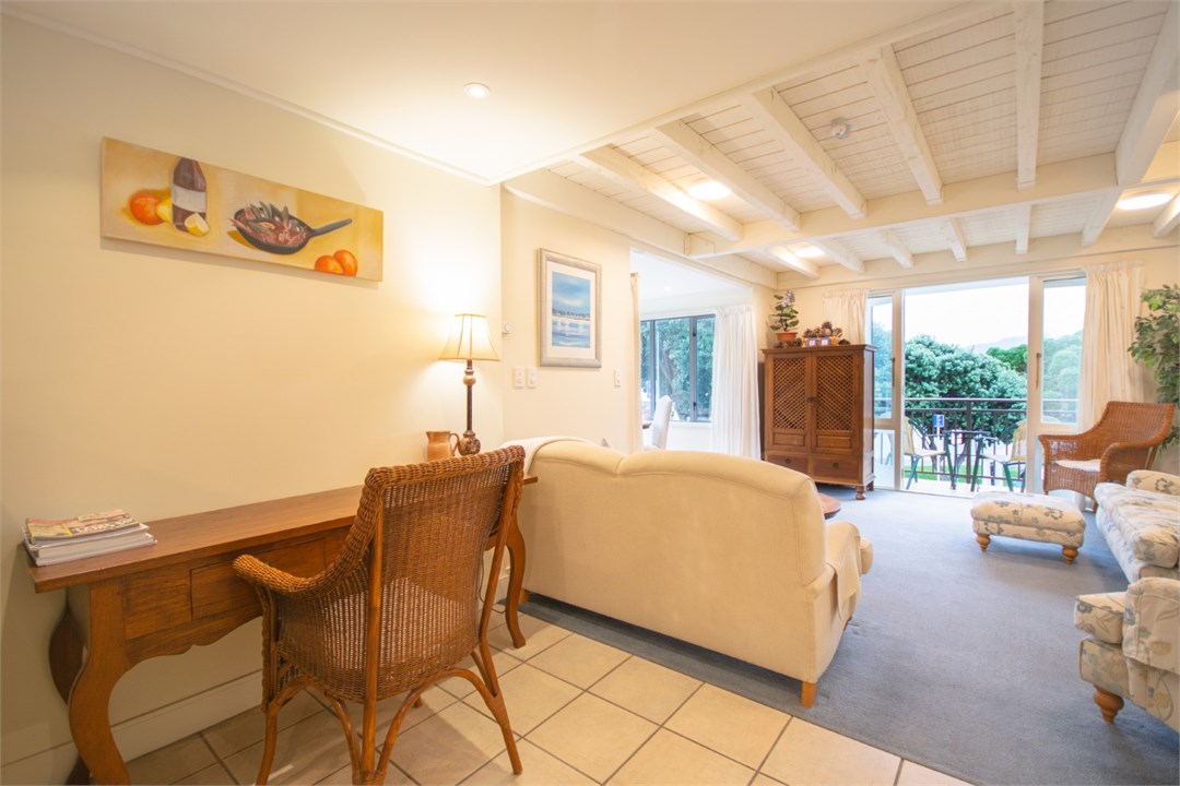 Living room has a TV and seating areas
