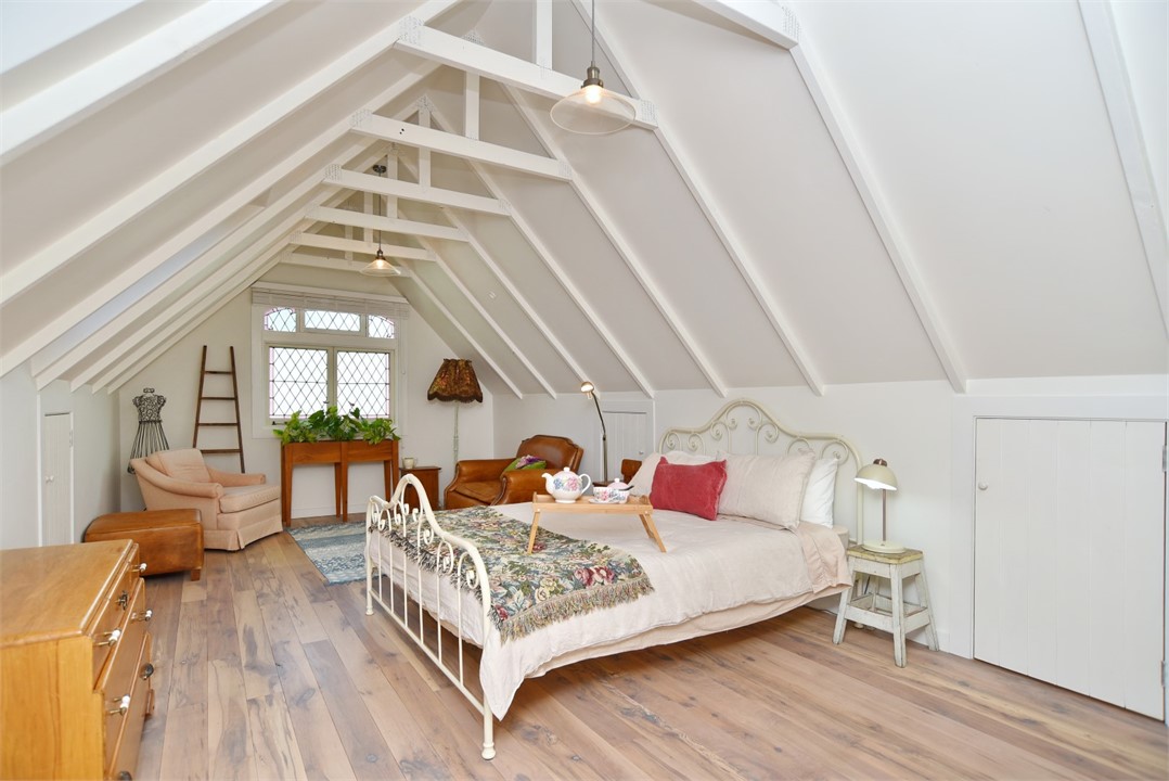 Bedroom has a Queen sized bed and a sitting area