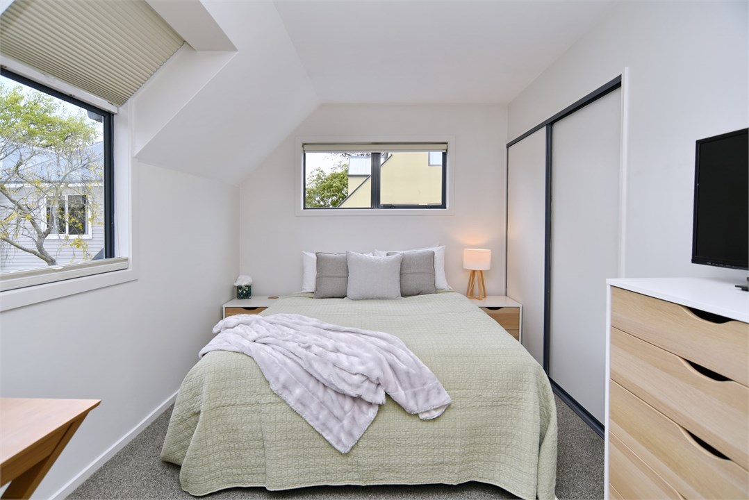 Bedroom 2 has a Queen bed and a TV