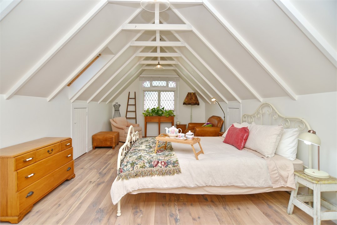 Bedroom has a Queen sized bed and a sitting area