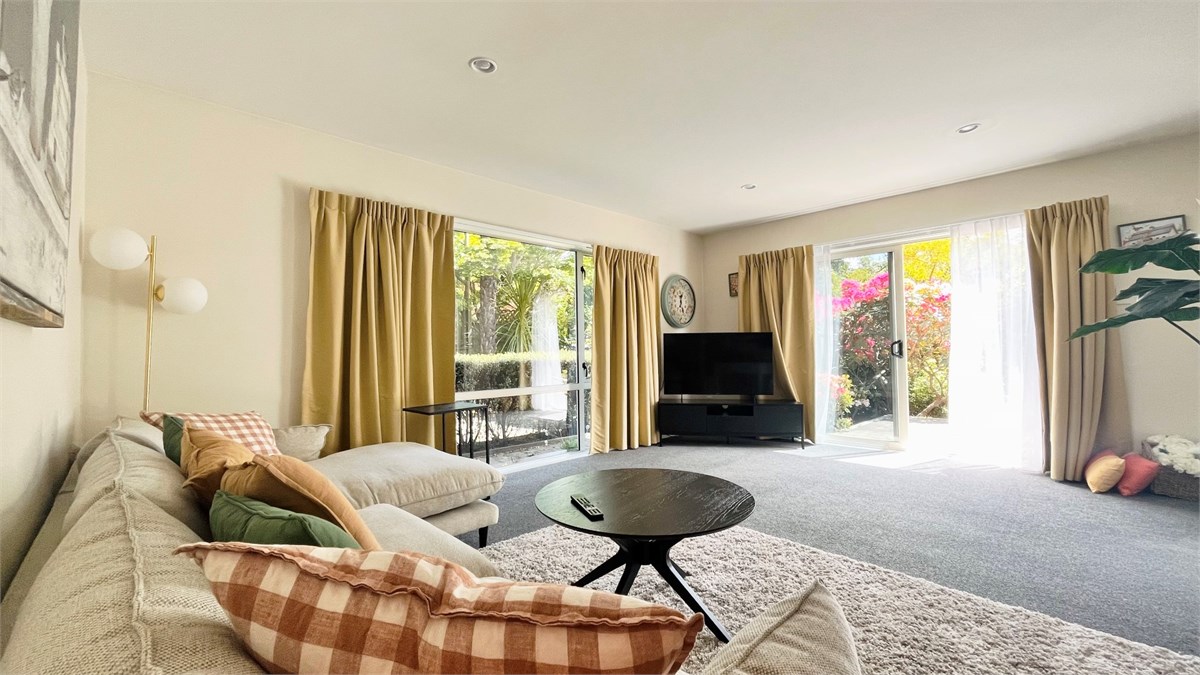 Living room has a TV and seating areas