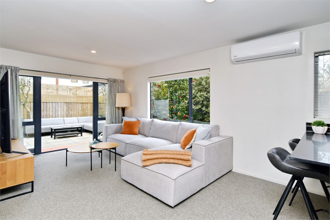 Living room has a TV and seating areas