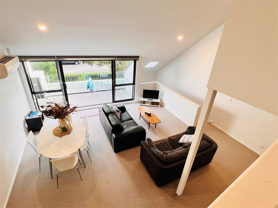 Living room has a TV and seating areas