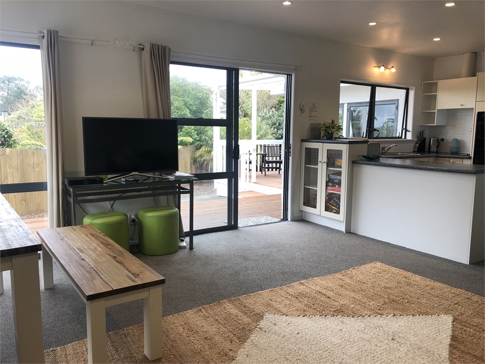 Lounge & dining flow to decks with BBQ, lounger & 