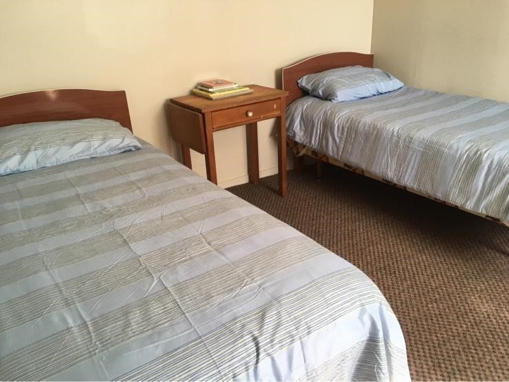 Kids room with 2 single beds and a bunk bed.