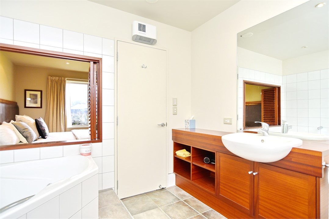 En suite to Bedroom 1 with a spa bath, shower and 