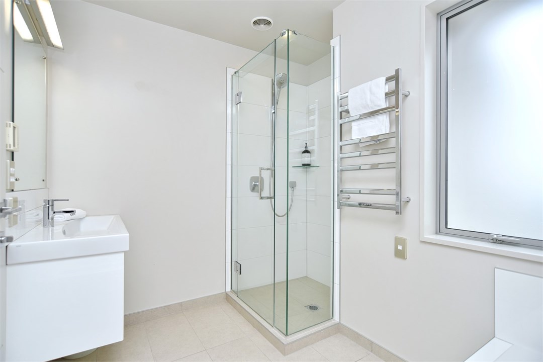 Bathroom 2 has a shower, toilet and a bath