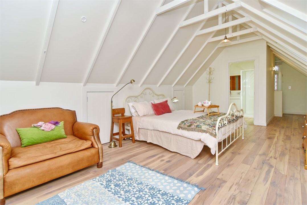 Bedroom has a Queen sized bed and a sitting area