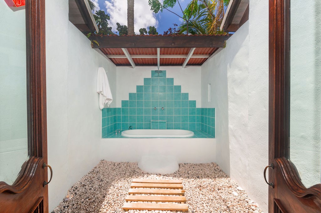 Outdoor bathroom with bath and rain shower