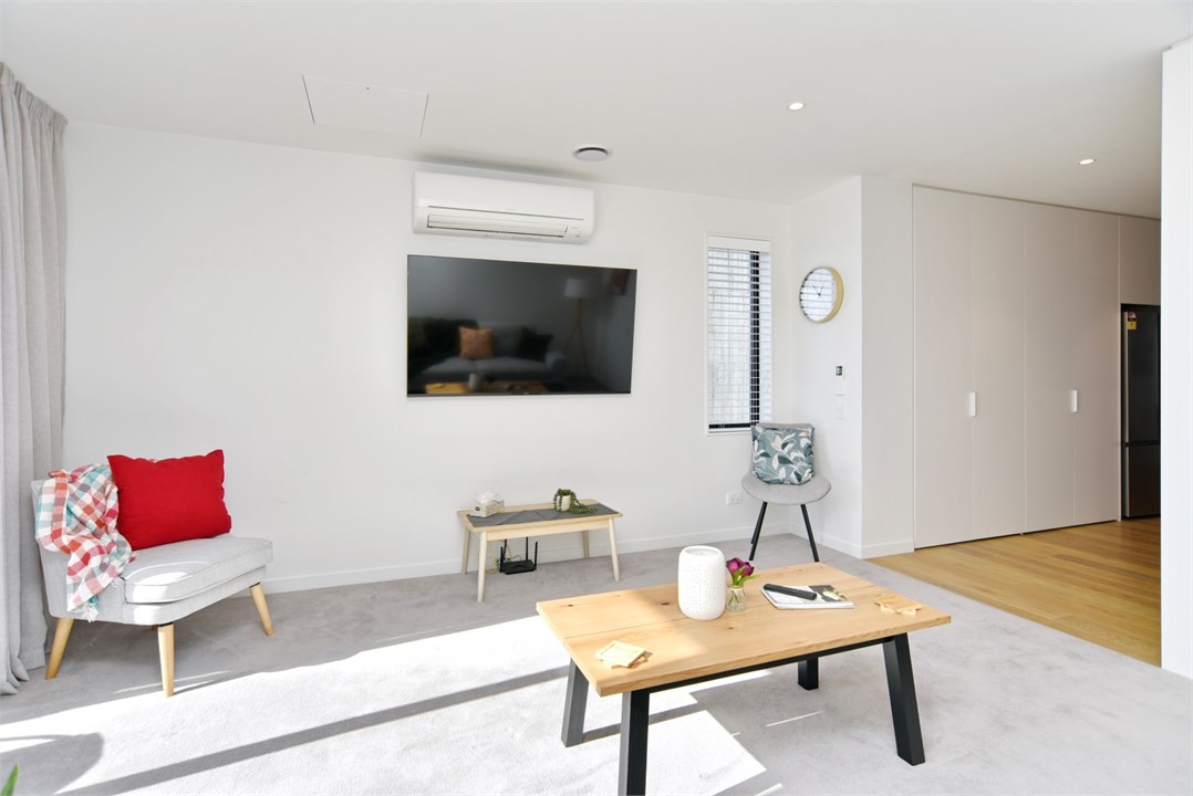 Living room has a TV and seating areas