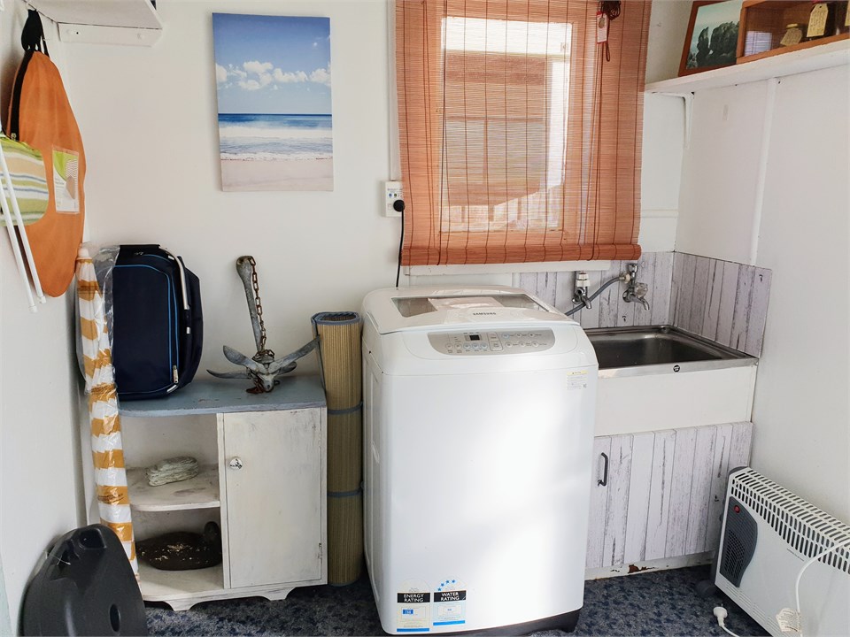 Laundry with picnic basket, sun umbrella and beach