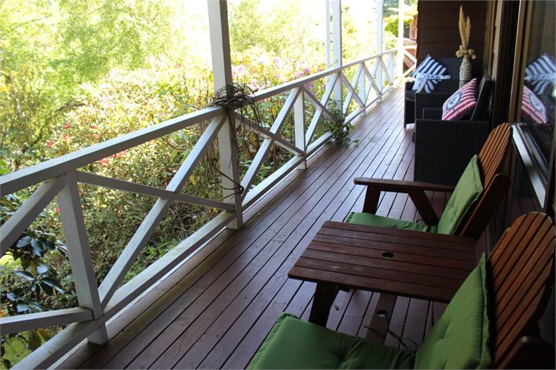 Private front deck looking over colourful garden  