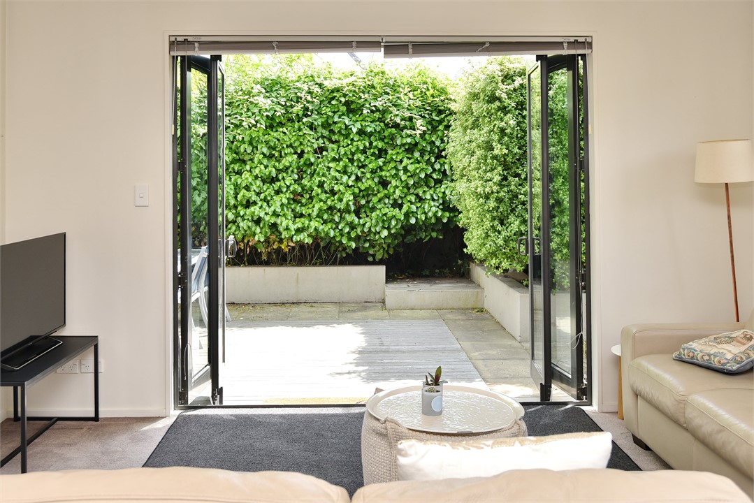 The apartment includes a lush private courtyard