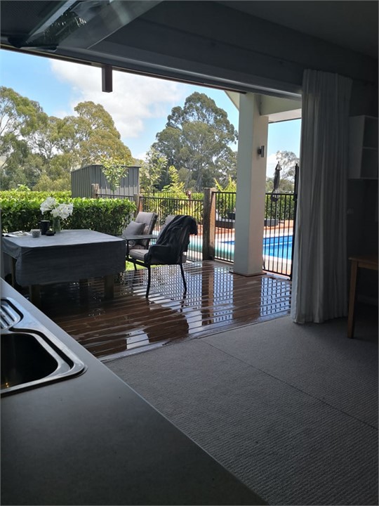 Bifold doors open to deck and through to pool area