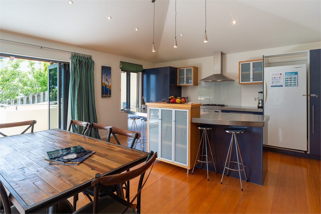 Dining/kitchen area w/door to sunny east veranda