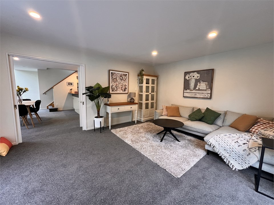 Living room has a TV and seating areas