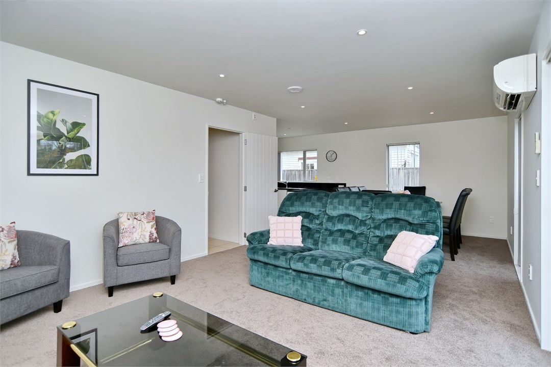 Living room with seating areas and a TV