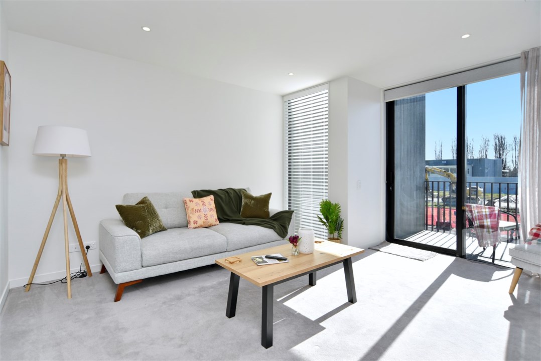 Living room has a TV and seating areas