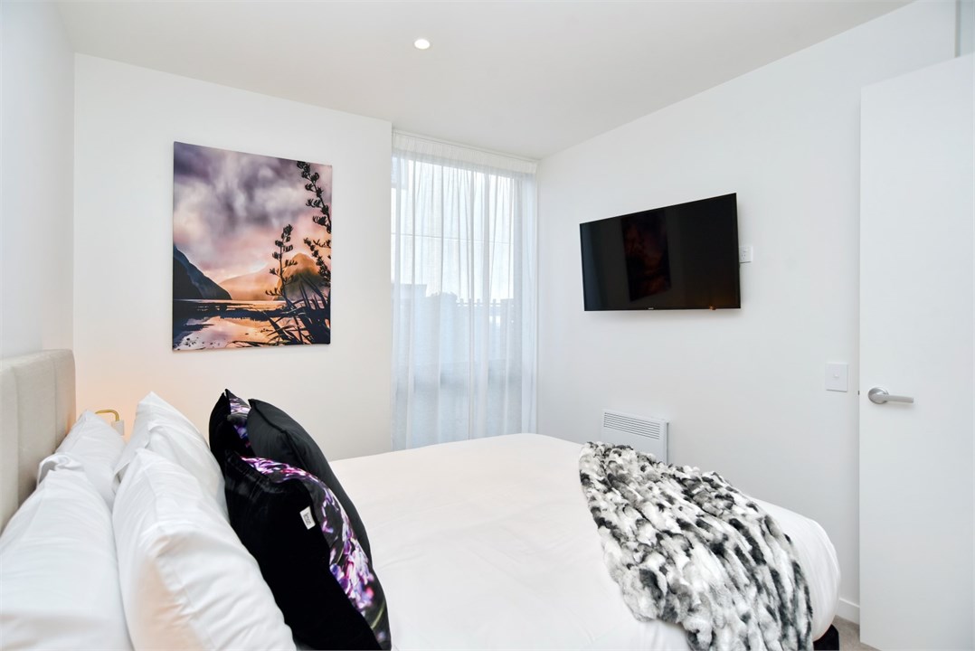 Bedroom 1 has a Queen bed and a TV