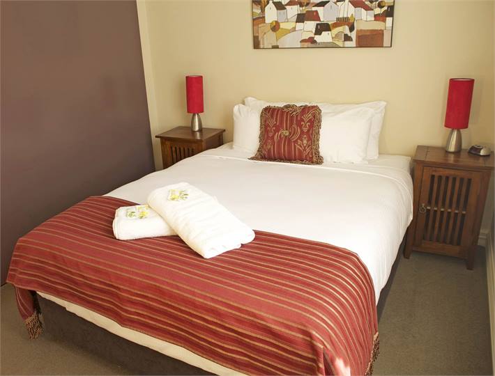 Queen bed with commercial linen