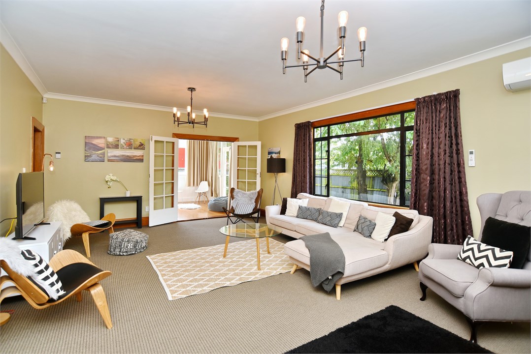 Living room has a TV and seating areas