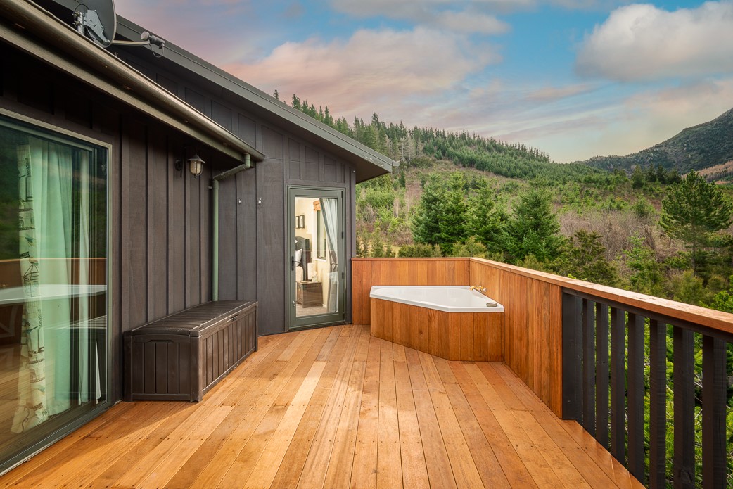 Bedroom has direct access to deck and outdoor bath