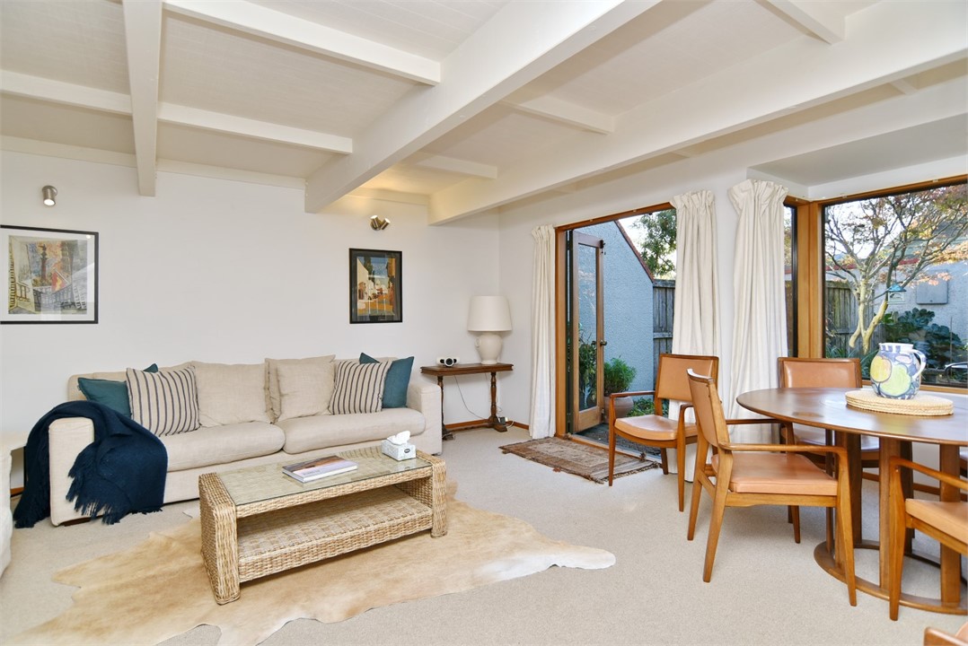 Living room with a seating area and a TV