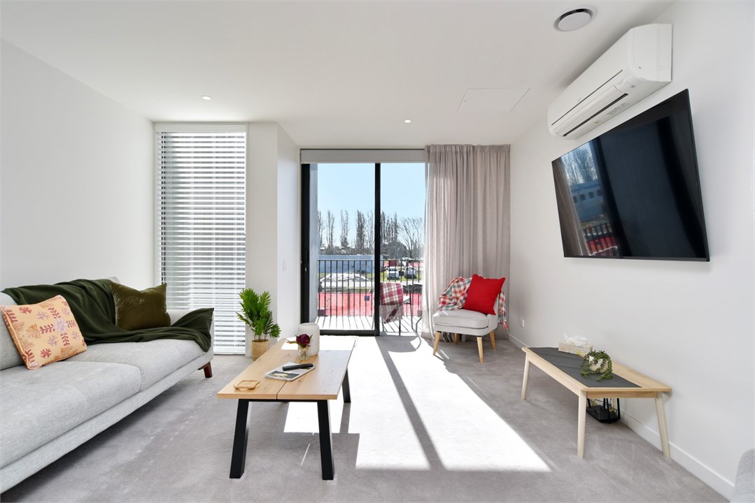 Living room has a TV and seating areas