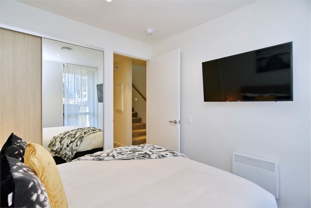 Bedroom 2 has a Queen bed and a TV