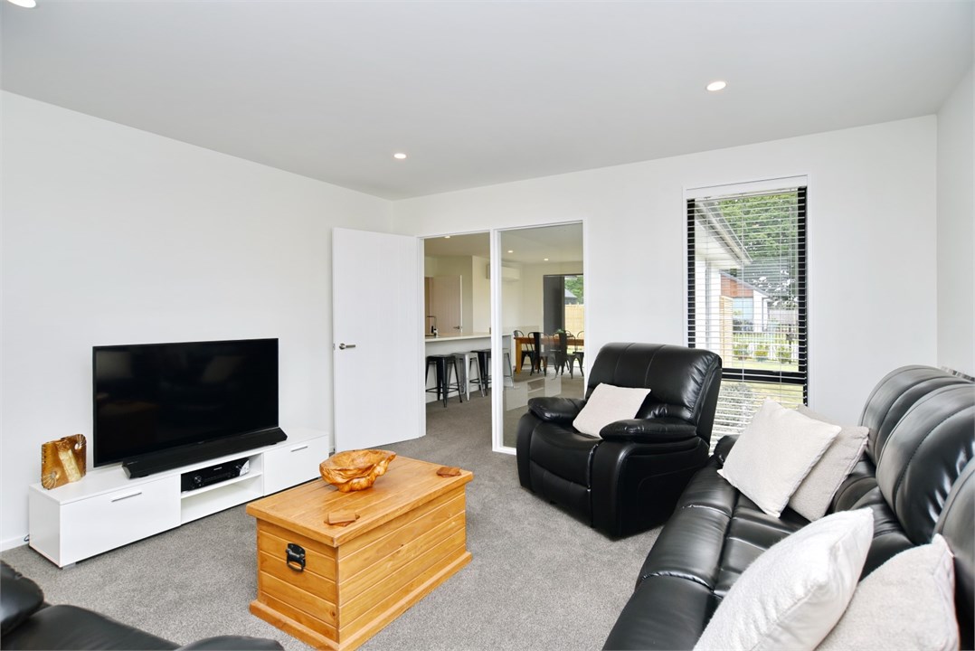 Living room has a TV and seating areas