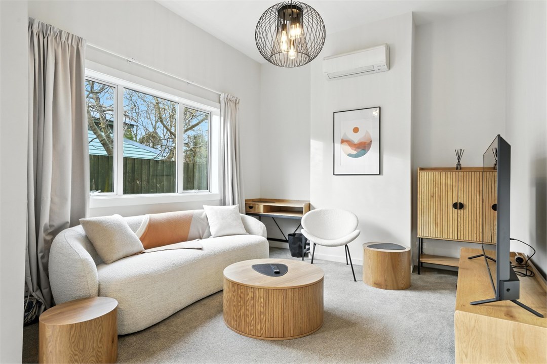 Living room with a TV and seating areas