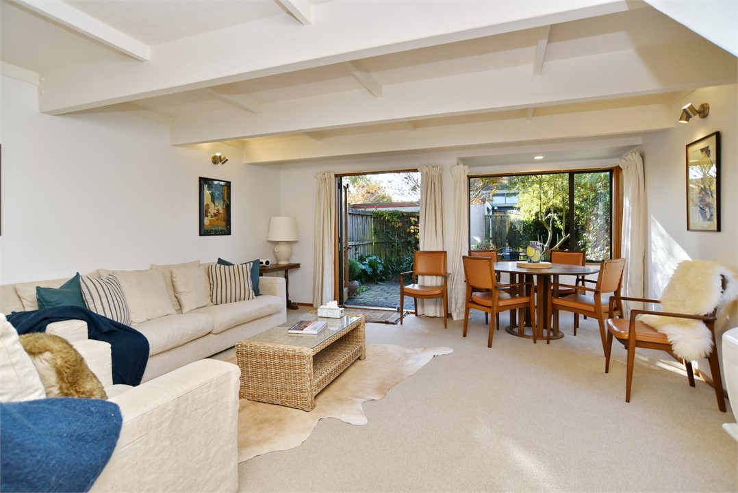 Living room with a seating area and a TV