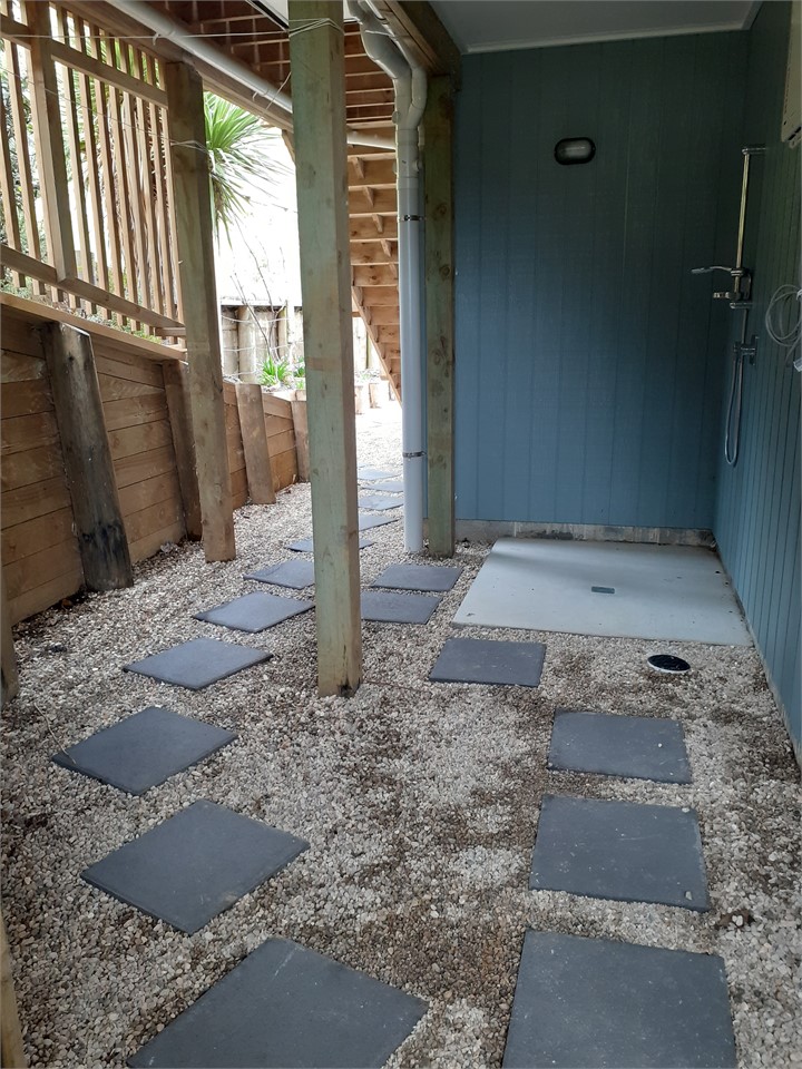 Outside shower, clothesline and storage area ...