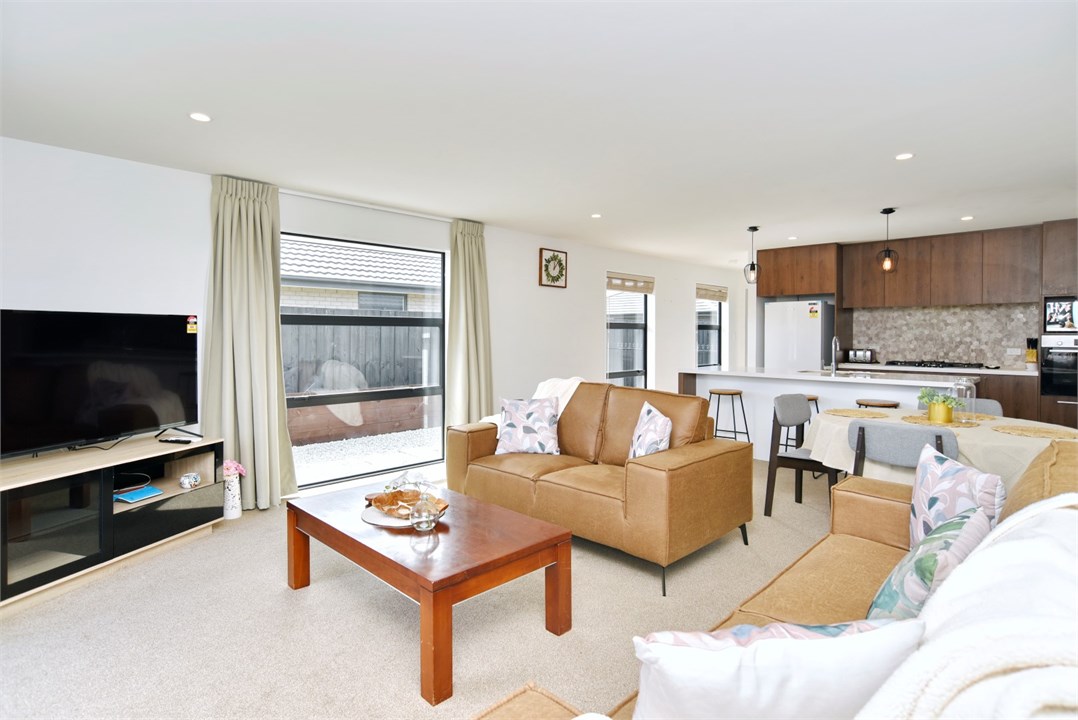 Living room has a TV and seating areas