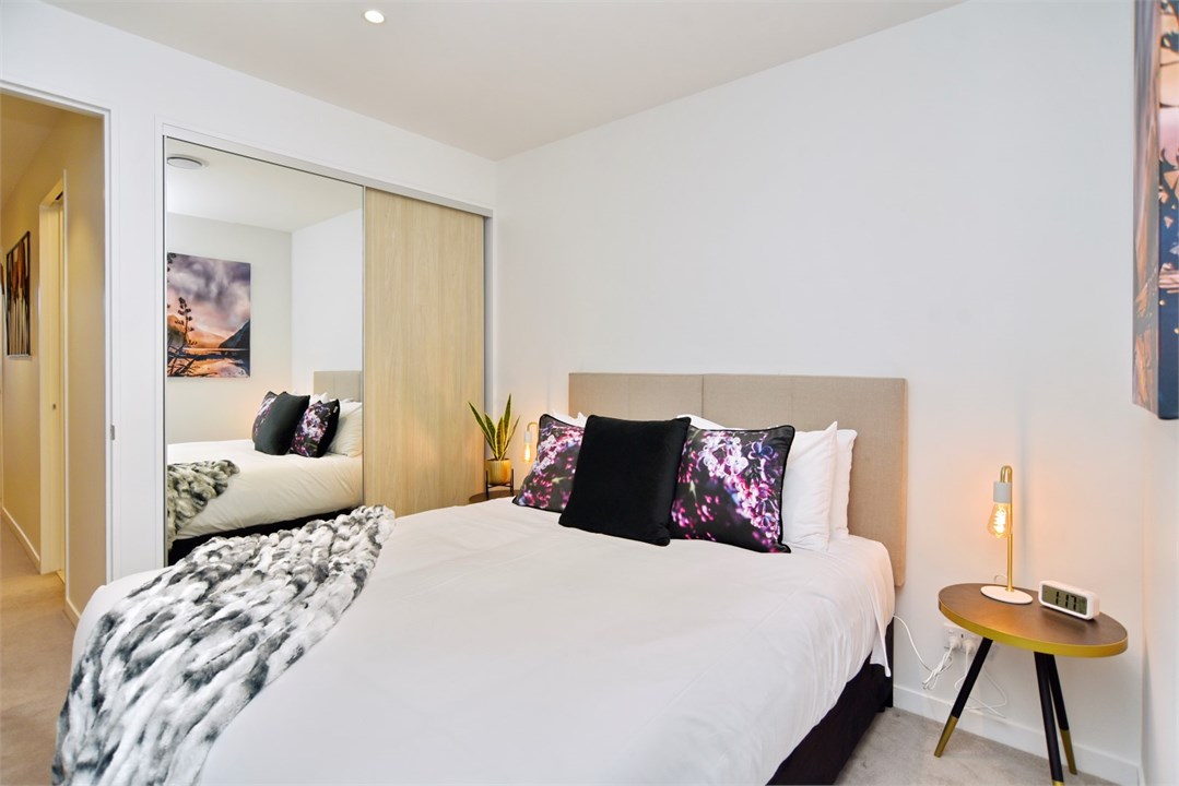 Bedroom 1 has a Queen bed and a TV