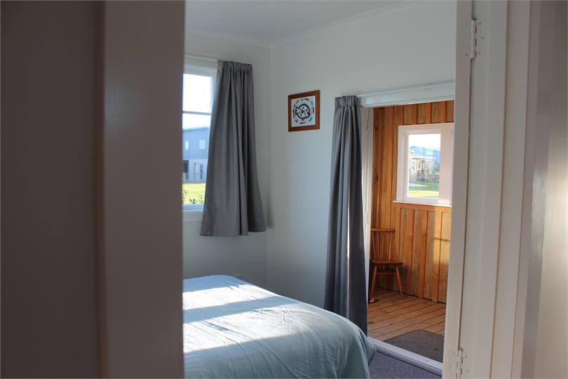 Bedroom One, 1x Queen Bed, French doors open to su