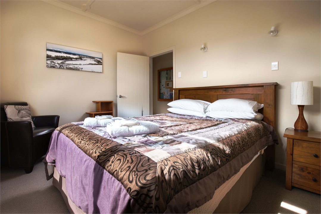 The middle bedroom has a queen bed and a view to t