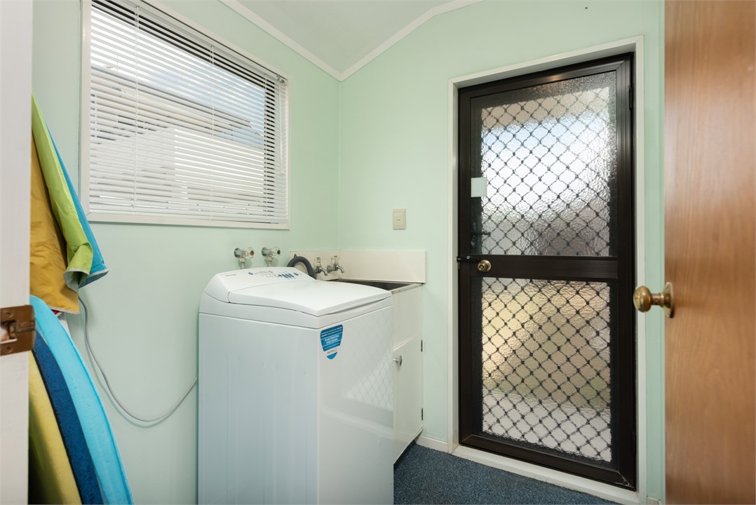 Laundry with clothes line out through the door