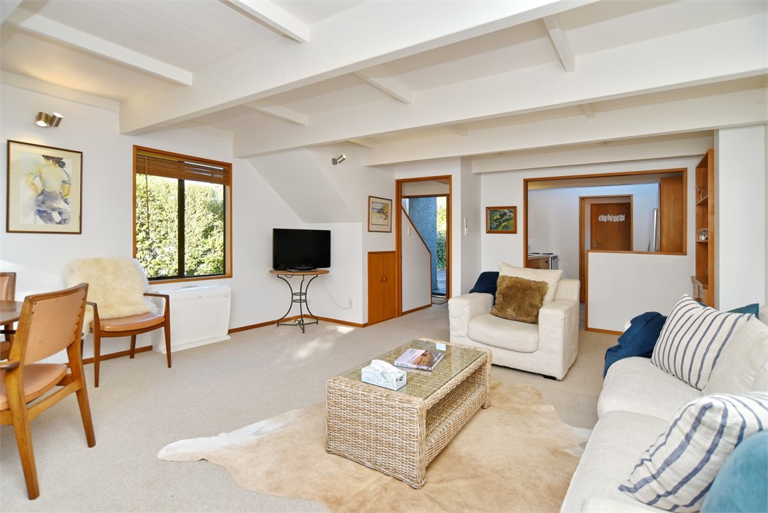 Living room with seating area and a TV